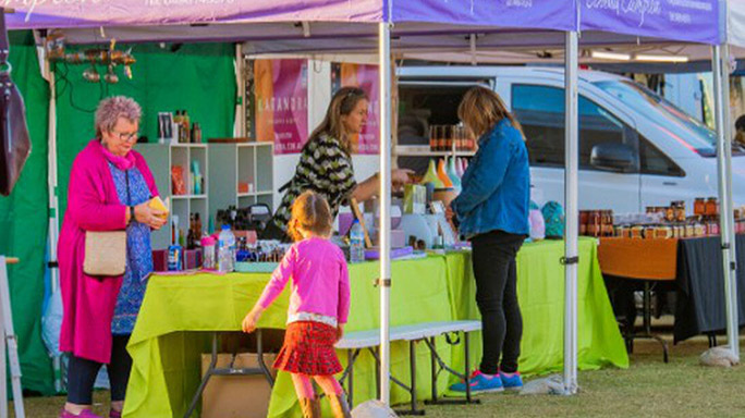 Stallholders selling items at Jarndunmunha Festival, people milling around