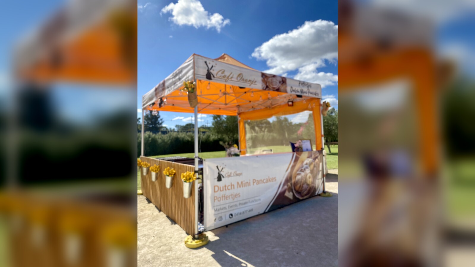 Cafe Oranje market marquee with orange canopy
