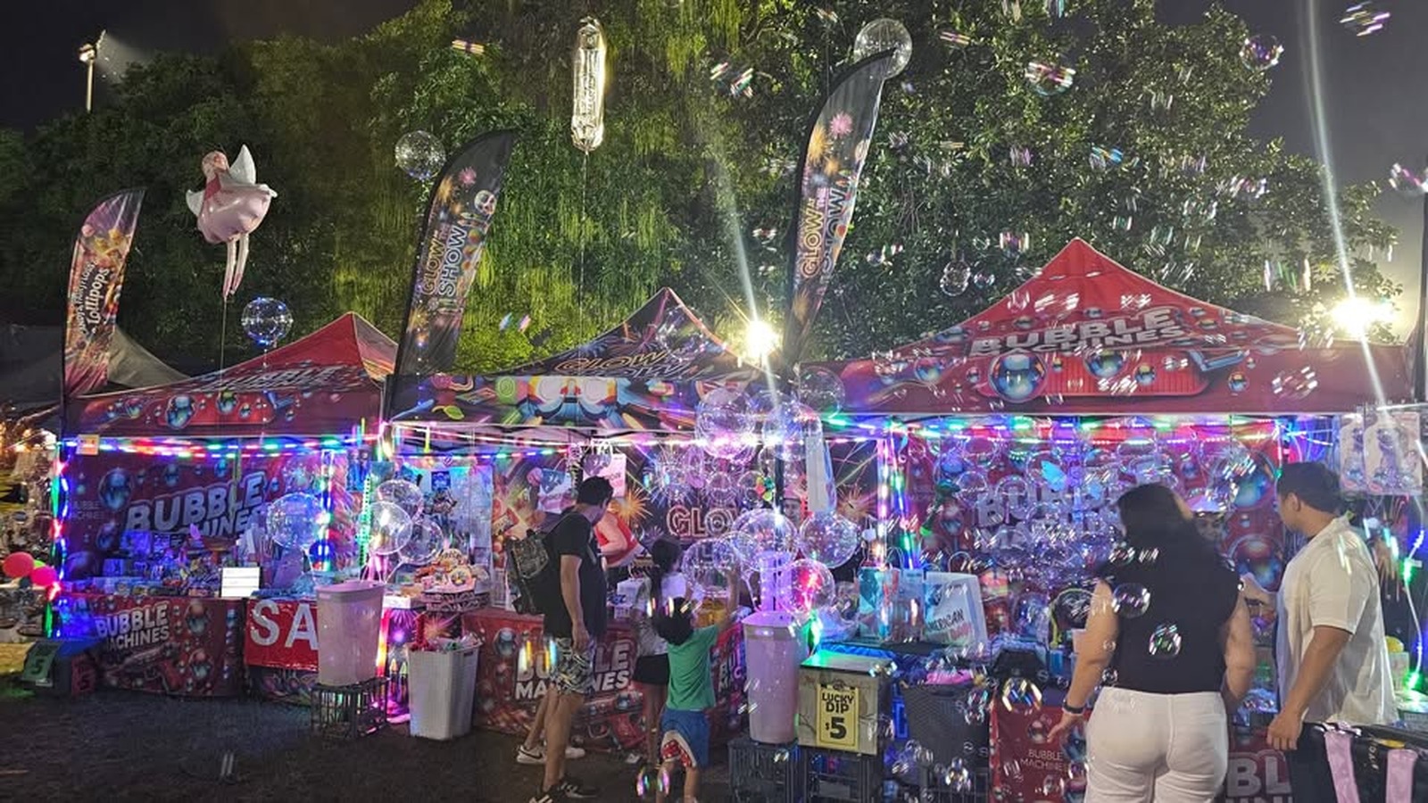 Lux Glow & Toy Co night stall lit with fairy lights and glow toys