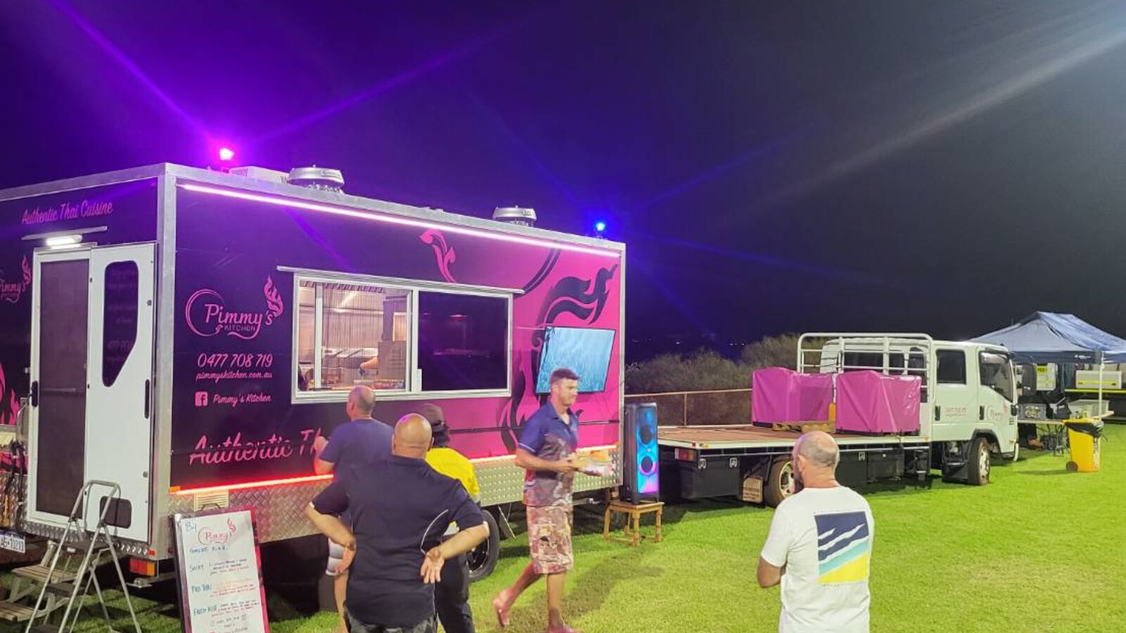 Pimmy's Kitchen pink and black food trailer advertising "Authentic Thai Cuisine"