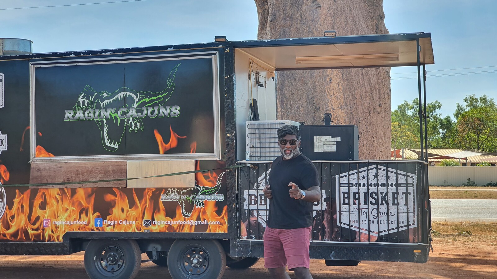 Ragin' Cajuns black food trailer with alligator logo and flame graphics