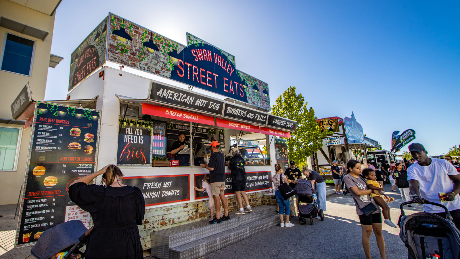 Swan Valley Street Eats food trailer with illuminated signage for burgers