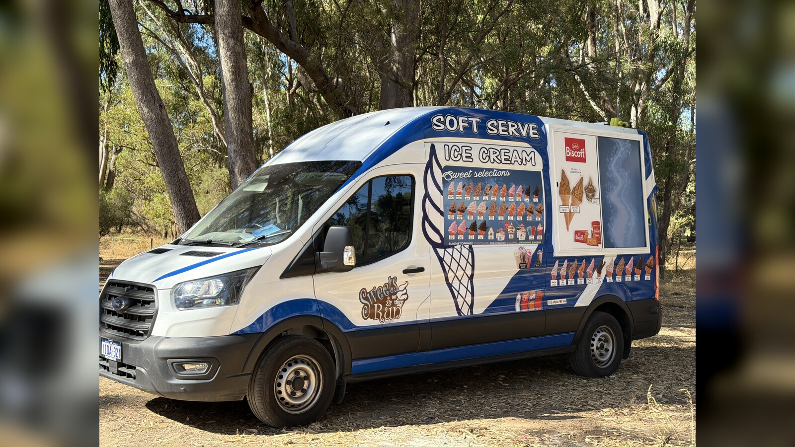 Sweets on the Run soft-serve ice cream van in blue and white livery with cone graphic and "Sweet Selections" menu