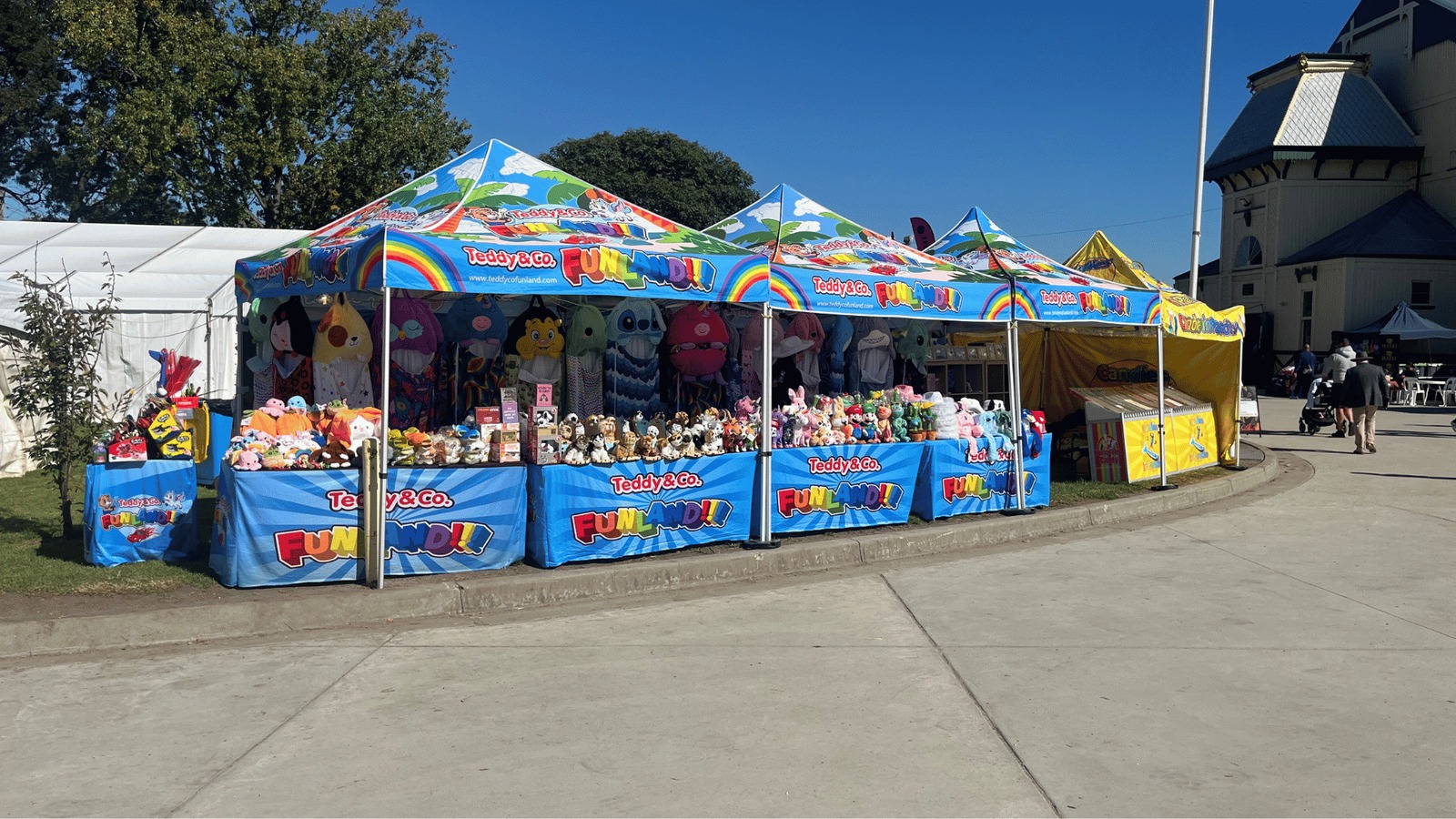 Row of Teddy & Co Funland marquees with rainbow "Funland!!!" signage