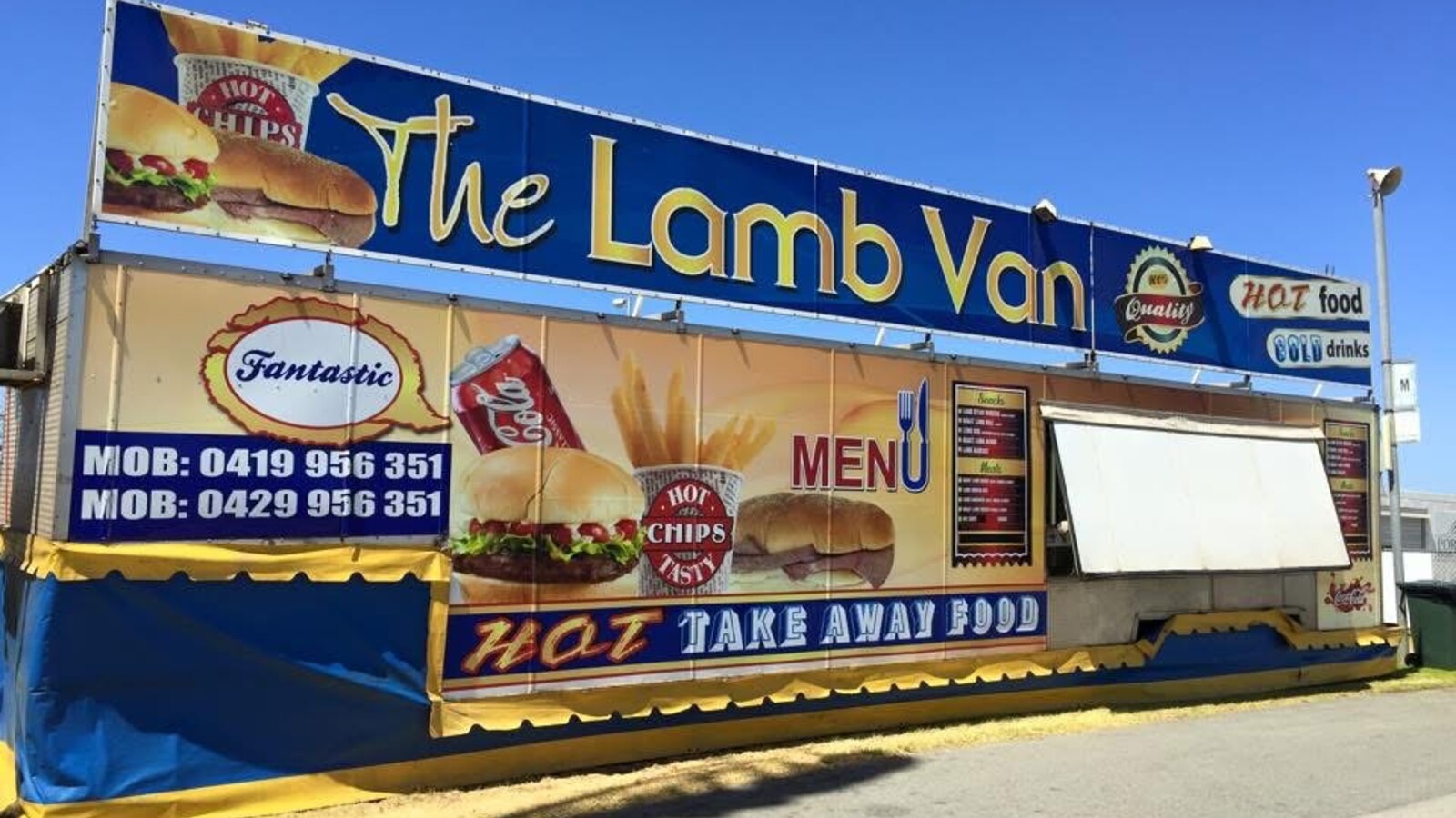 The Lamb Van food trailer with blue and yellow "Hot Food