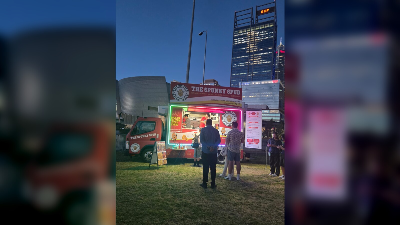 The Spunky Spud food truck with neon-lit sign and potato mascot logo